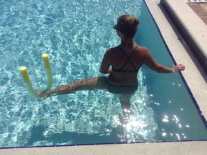 pool exercising with noodles